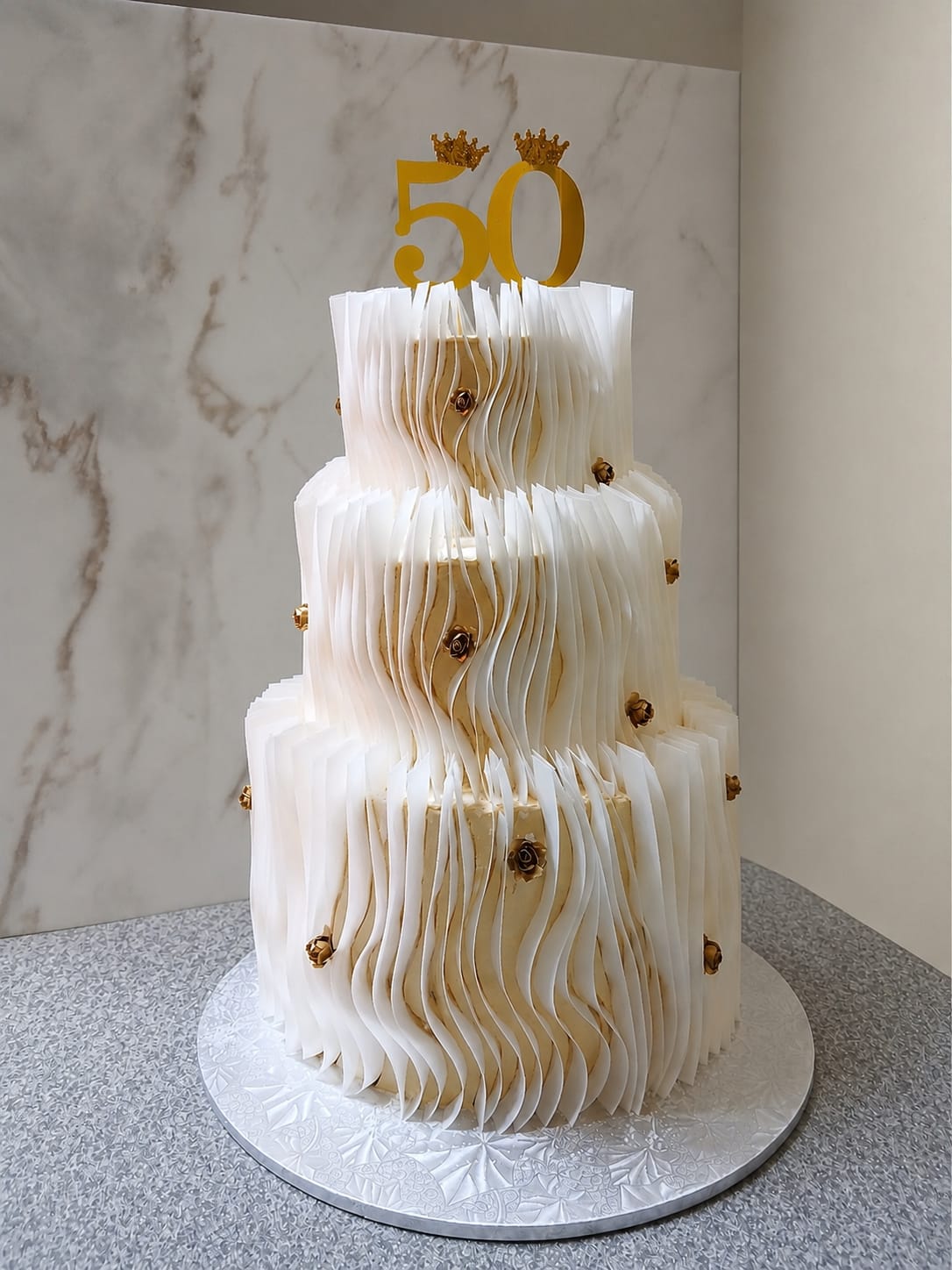 Limpopo wedding cake with white waves and gold details by Bridget