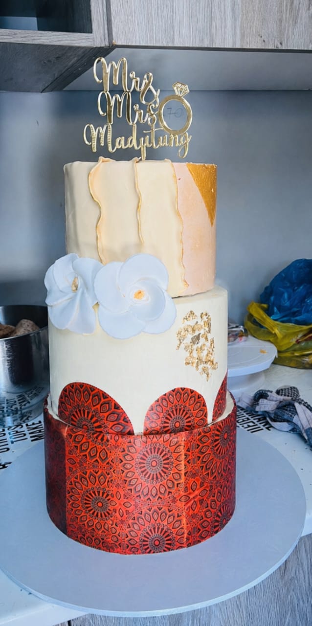 Traditional red and gold three tier wedding cake